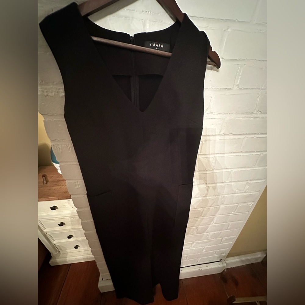 Black wide leg romper with pocket detail at sides. Extremely flattering fit.